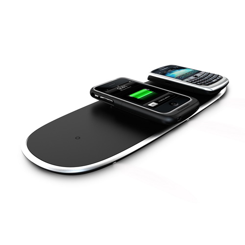 Two smartphones are placed on a sleek, black wireless charging pad. One phone shows a green battery icon indicating its charging. The pad and phones are on a white background.