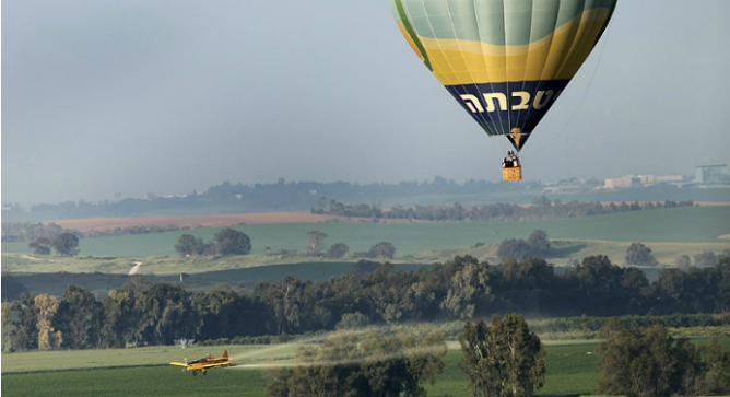 A hot air balloon flies over the Israeli countryside. Photo by Moshe Shai/Flash90.