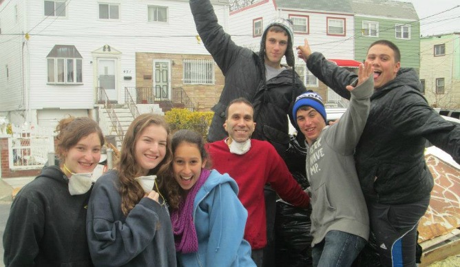 Ayelet Koplon, Lipaz Hirsch, Dafna Katz, Stuart Katz (in red sweatshirt), Brad Eckman, Yoni Wolf and Rami Lesnick participating in a cleanup at Arverne, a neighborhood on the hard-hit Rockaway Peninsula in New York.