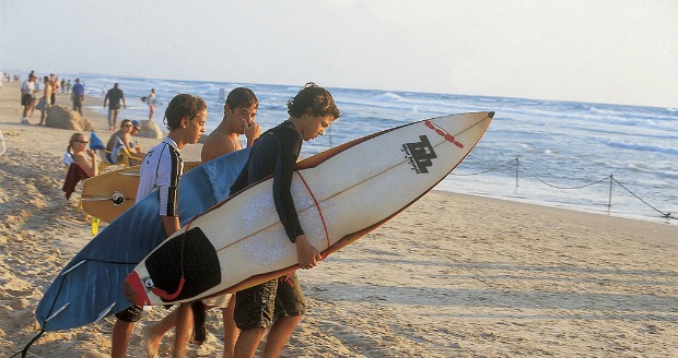 Surfers on the beach in Haifa.