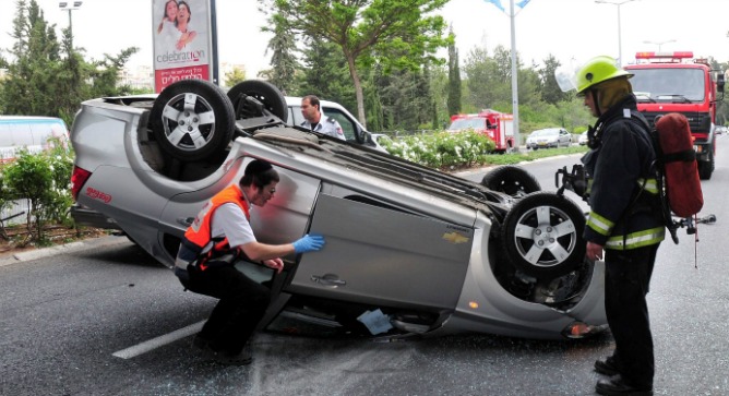 Magen David Adom paramedics and rescue team members at the site of a car accident in Haifa. Photo by Flash90.