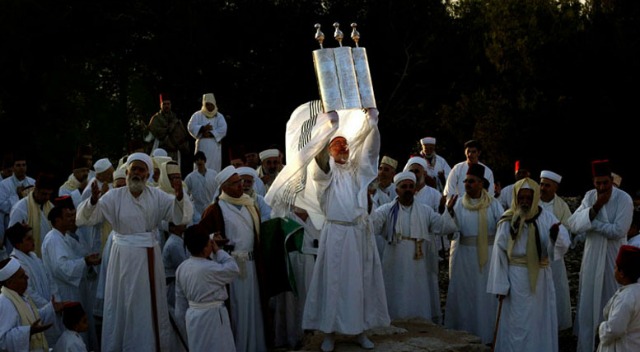 A senior priest of the tiny ancient Samaritan sect holds a Torah during the pilgrimage for the holiday of Tabernacles (Sukkot). Photo by Gali Tibbon
