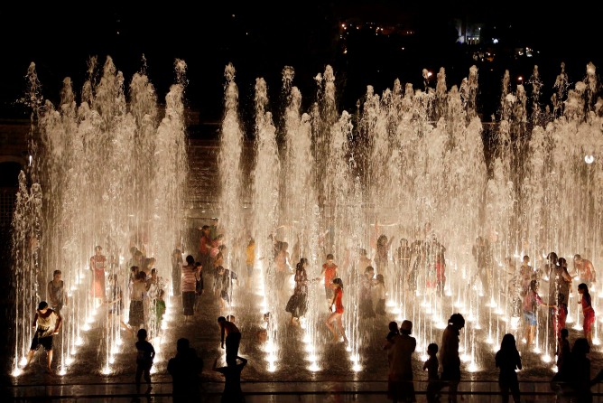 children playing in fountains