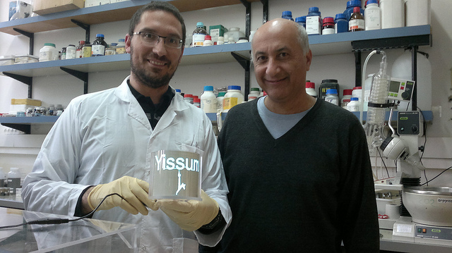 Magdassi with graduate student Alon Shimoni and the lamp lit with conductive nanoparticles. Photo by Abigail Klein Leichman