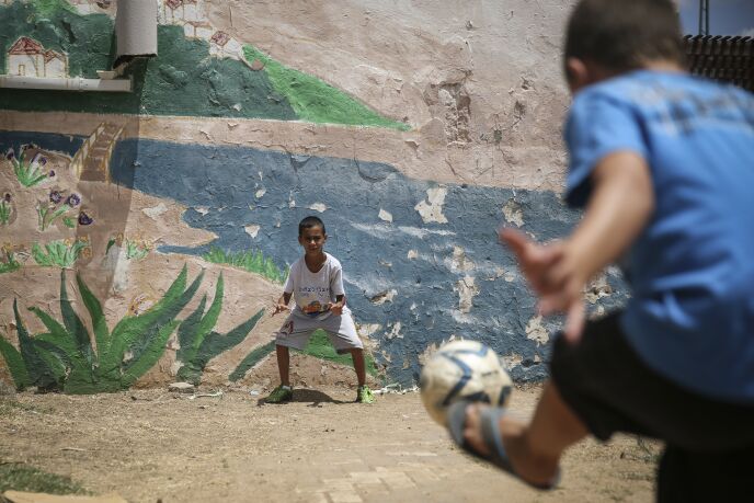 Children playing outside a bomb shelter that also functions as a children's summer club in the southern Israeli town of Kiryat Malachi, July 14, 2014. Photo by Hadas Parush/FLASH90