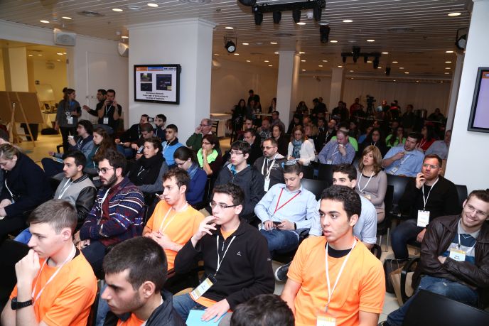Participants listen to presentations at the event.