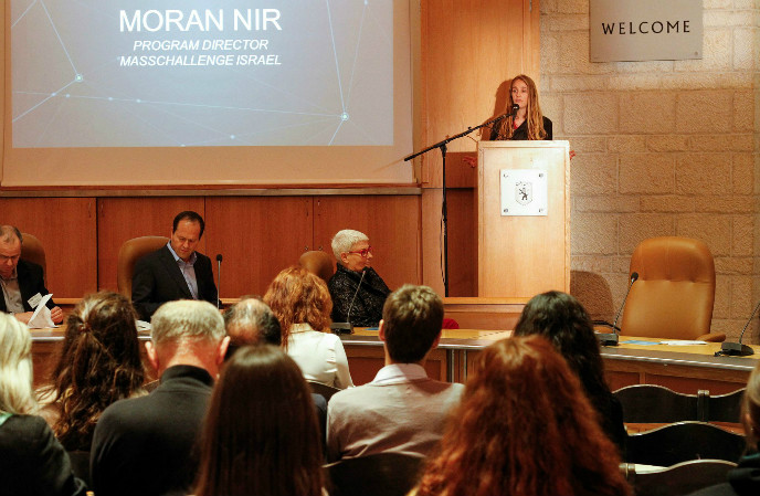MassChallenge Israel program director Moran Nir speaking at the event at Jerusalem City Hall, with Mayor Nir Barkat and EMC VP Orna Berry in the foreground. Photo: Yaniv Yur