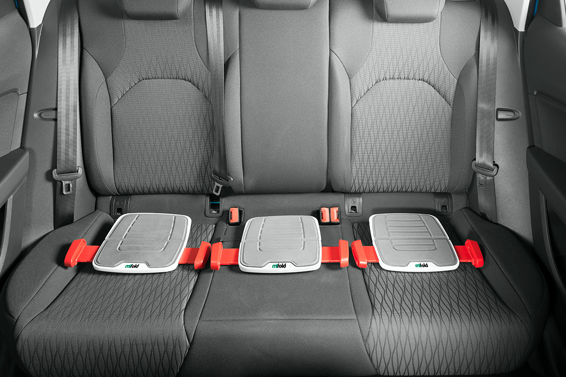mifold Three of the booster seats can fit comfortably in the backseat of the car. Photo: courtesy