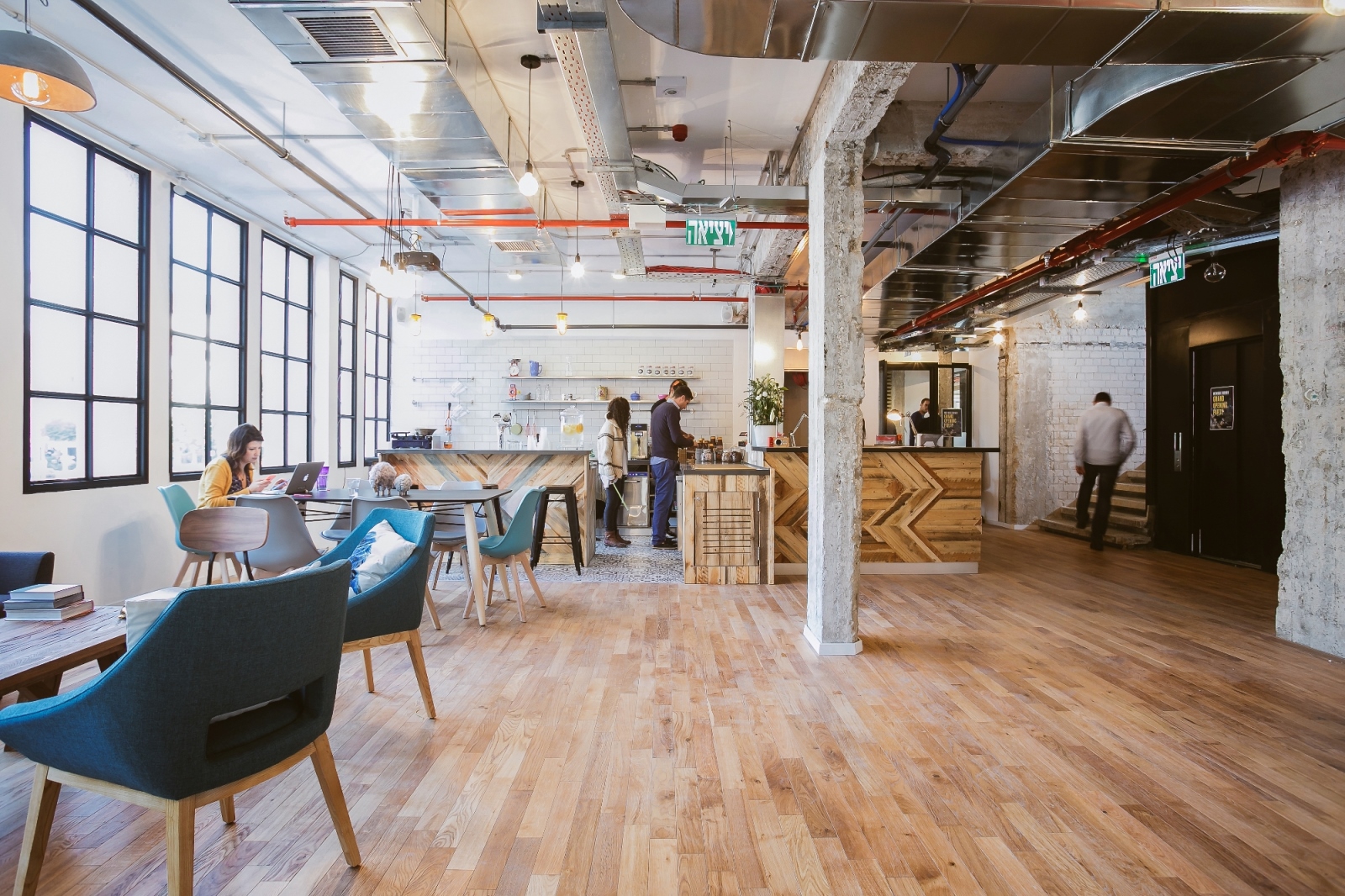 Large windows are a main design element at WeWork’s Tel Aviv location on Dubnov Street. Photo by Shiran Carmel