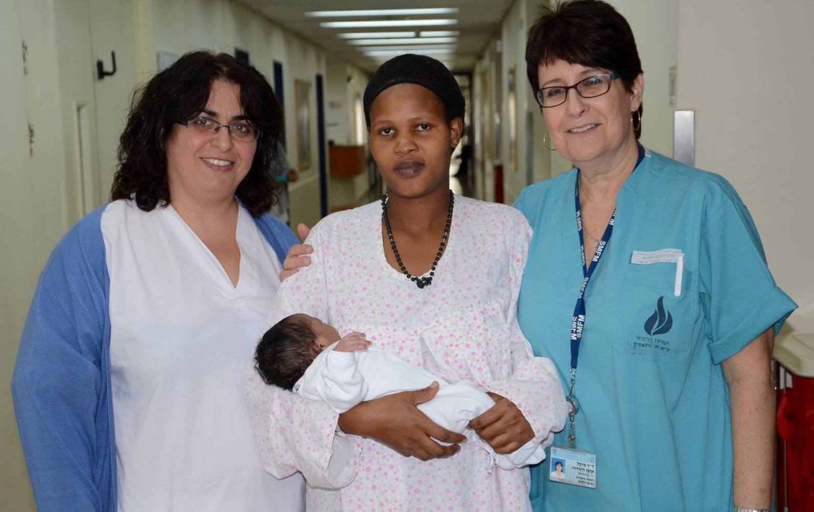 Elieth and baby Laura, flanked by nurse Limor Cooper-Sasson and Dr. Michal Kobo in the maternity department at Wolfson. Photo by Batak Nuna Elieth and baby Laura, flanked by nurse Limor Cooper-Sasson and Dr. Michal Kobo in the maternity department at Wolfson. Photo by Batak Nuna