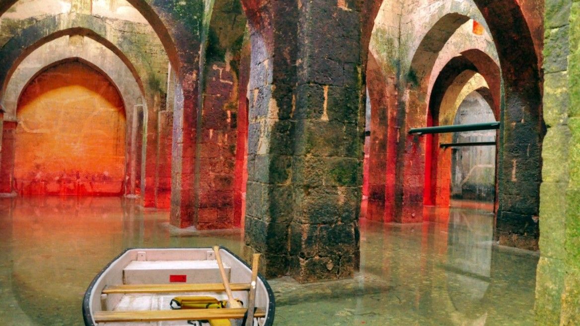 Boating through the underground reservoir in Ramla. Photo via BibleWalks.com