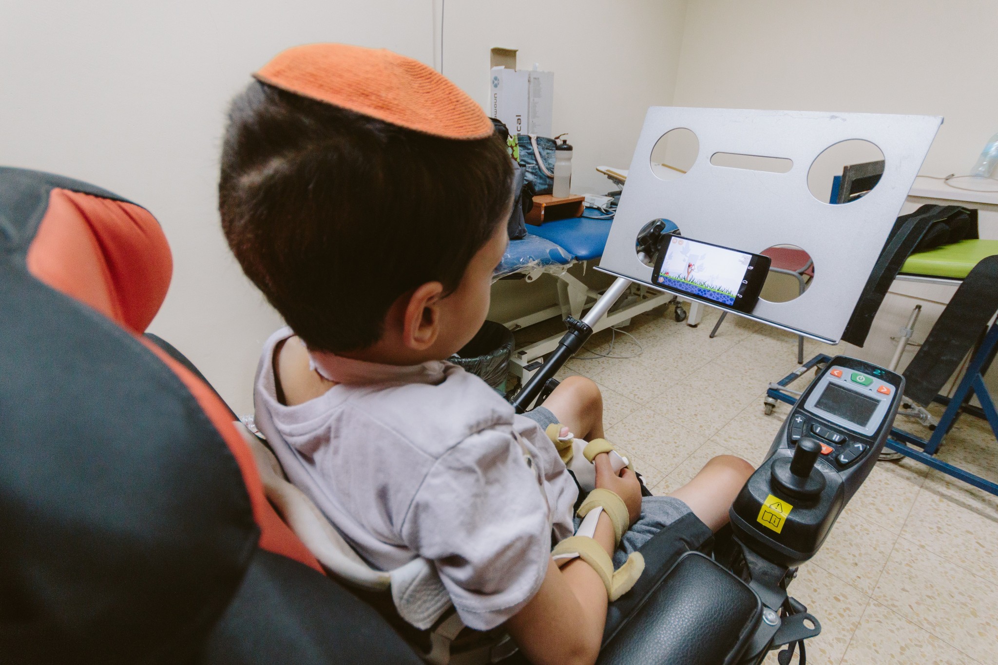 This young boy with disabilities is now able to use a smartphone. Photo by Basti Hansen