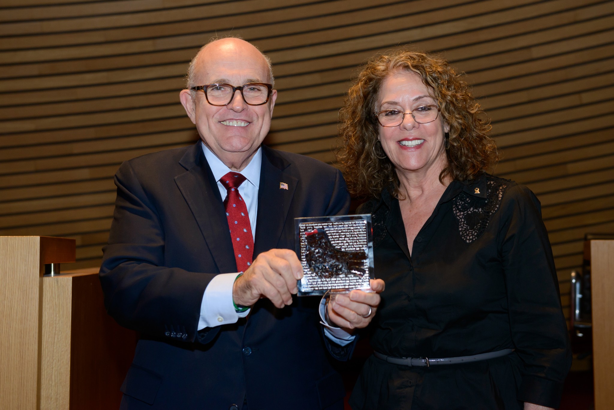 Former New York City Mayor Rudolph Giuliani holds a dove of peace plaque given to him by BGU President Prof. Rivka Carmi. Photo by Dani Machlis/BGU