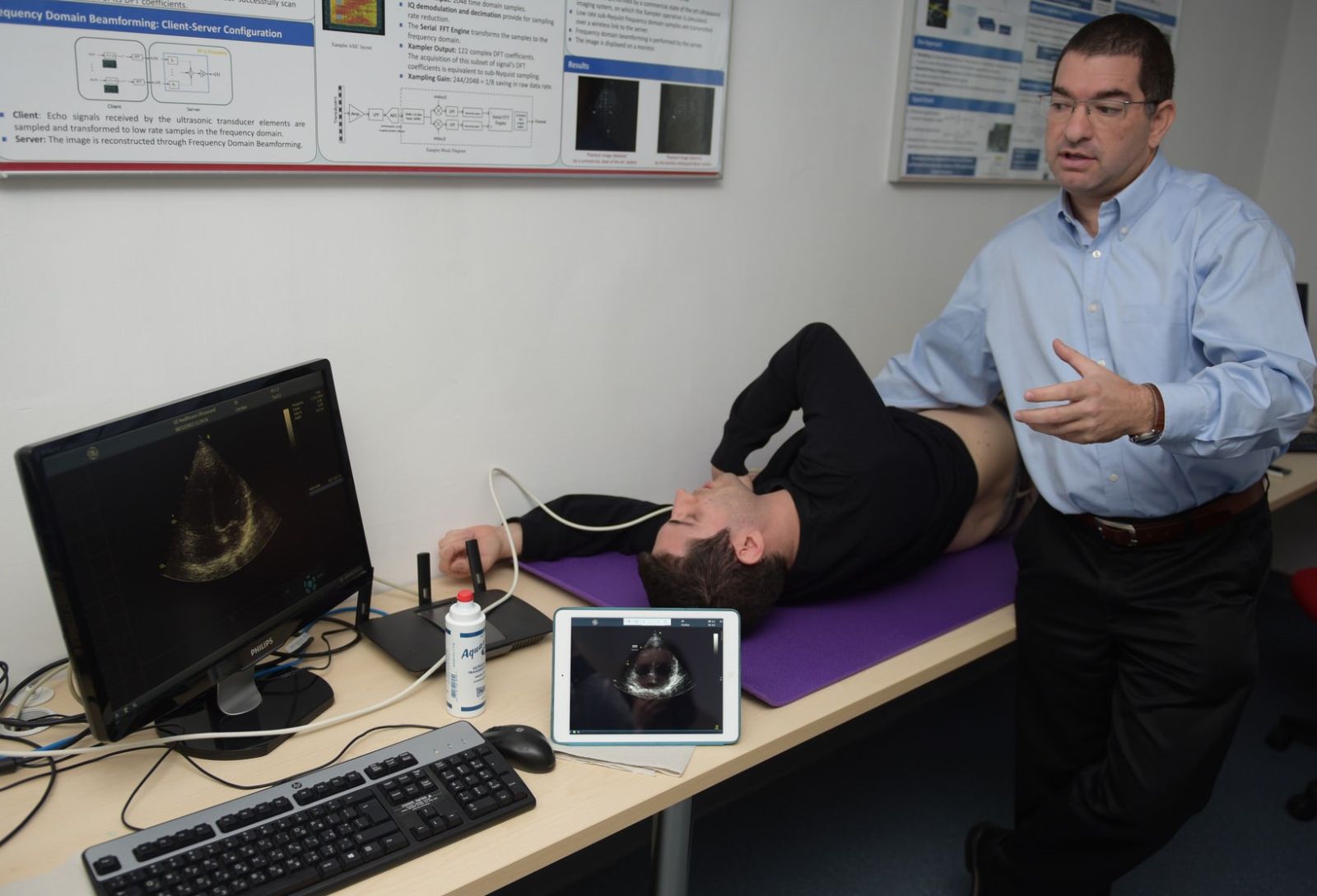 Dr. Shai Tejman-Yarden demonstrating the mobile ultrasound imaging system on Technion student Regev Cohen. Photo courtesy of Technion Spokesperson’s Office