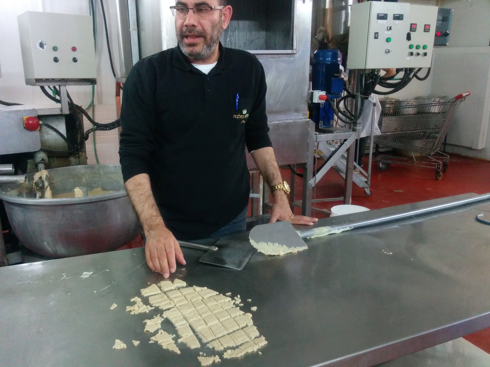 Shafrir Levi slicing freshly made vanilla halva at the Halva Kingdom factory. Photo by Abigail Klein Leichman Shafrir Levi slicing freshly made vanilla halva at the Halva Kingdom factory. Photo by Abigail Klein Leichman
