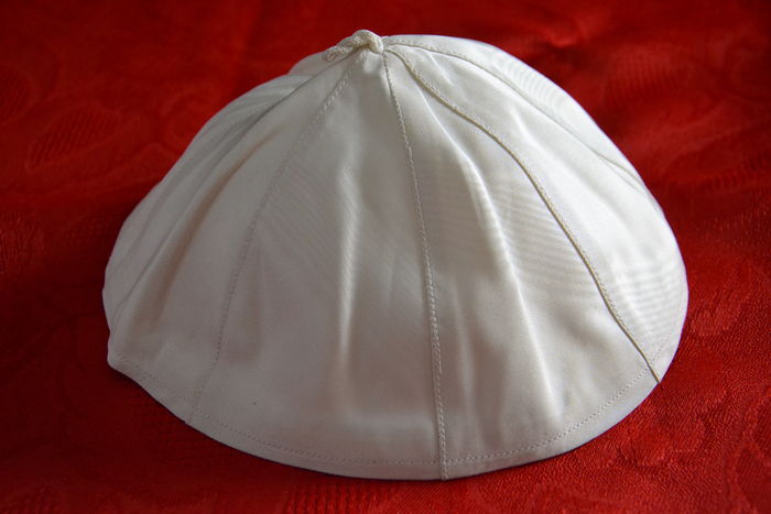 Pope Francis traded his white skullcap with a TV journalist. Photo via Catawiki