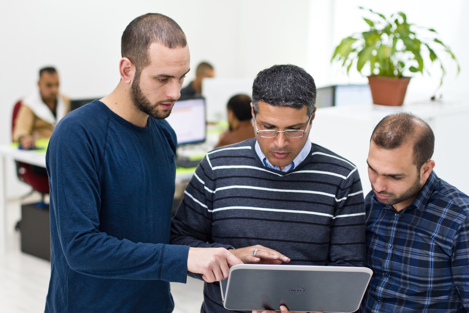 SadelTech CEO Ibrahim Sana conferring with employees. Photo by Anas Abu-Daabis
