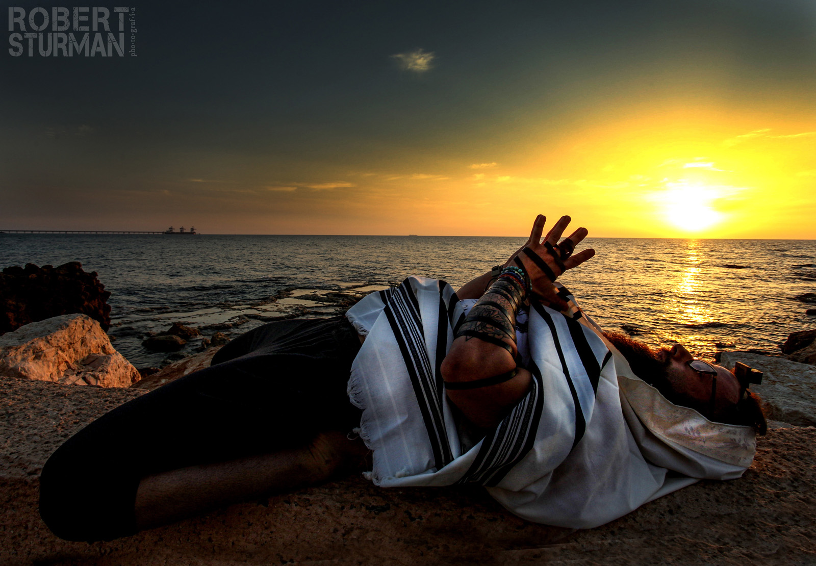 Seth Kaufman doing yoga on the beach in Caesarea as part of his morning prayer ritual. Photo by Robert Sturman
