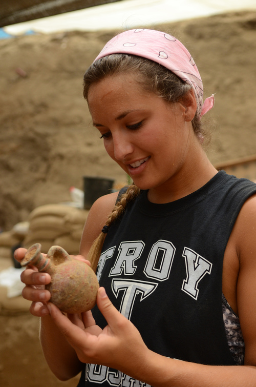 A student examines a 10th-9th century BCE juglet in the Philistine cemetery in Ashkelon. Photo by Melissa Aja/Leon Levy Expedition