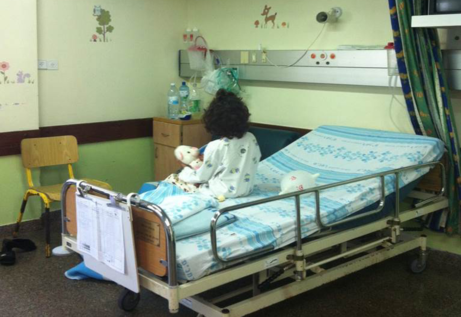 A Syrian patient hugs a teddy bear at Rambam Health Care Campus in Haifa. Photo courtesy A Syrian patient hugs a teddy bear at Rambam Health Care Campus in Haifa. Photo courtesy