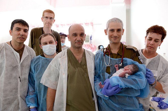 Baby Israel with the IDF team that delivered him at the IDF field hospital in Bogo City. Photo courtesy IDF 