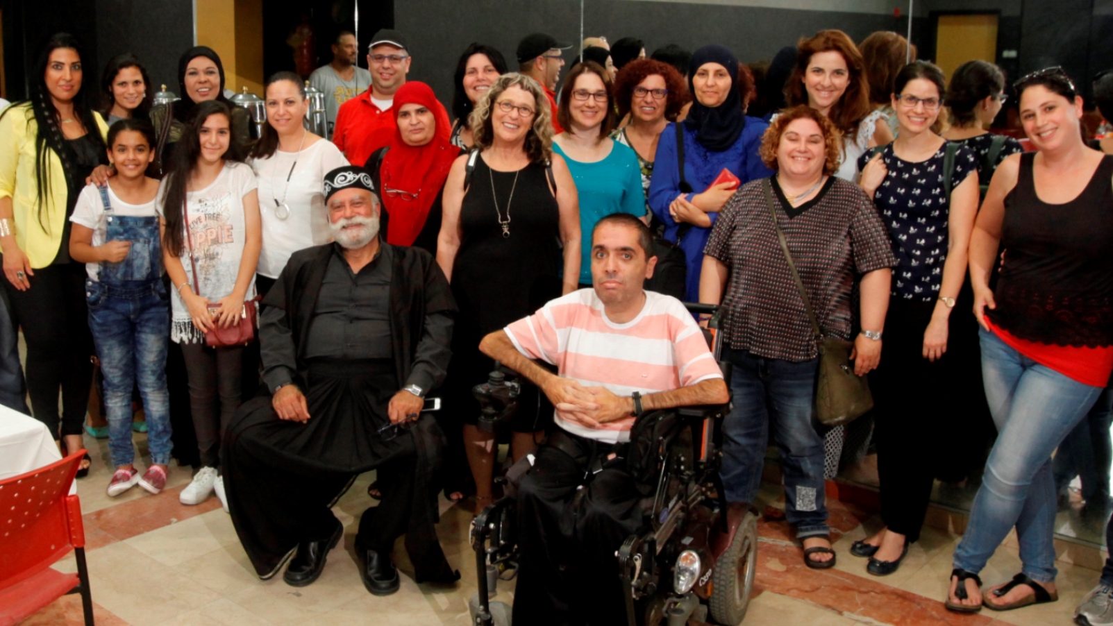 Beit Issie Shapiro parent leaders from Ra’anana and Kalansua at the Sindian Center. Nawaf Zmiro, head of the Sindian Center’s Family Advancement Center, is in front in the wheelchair. Photo: courtesy