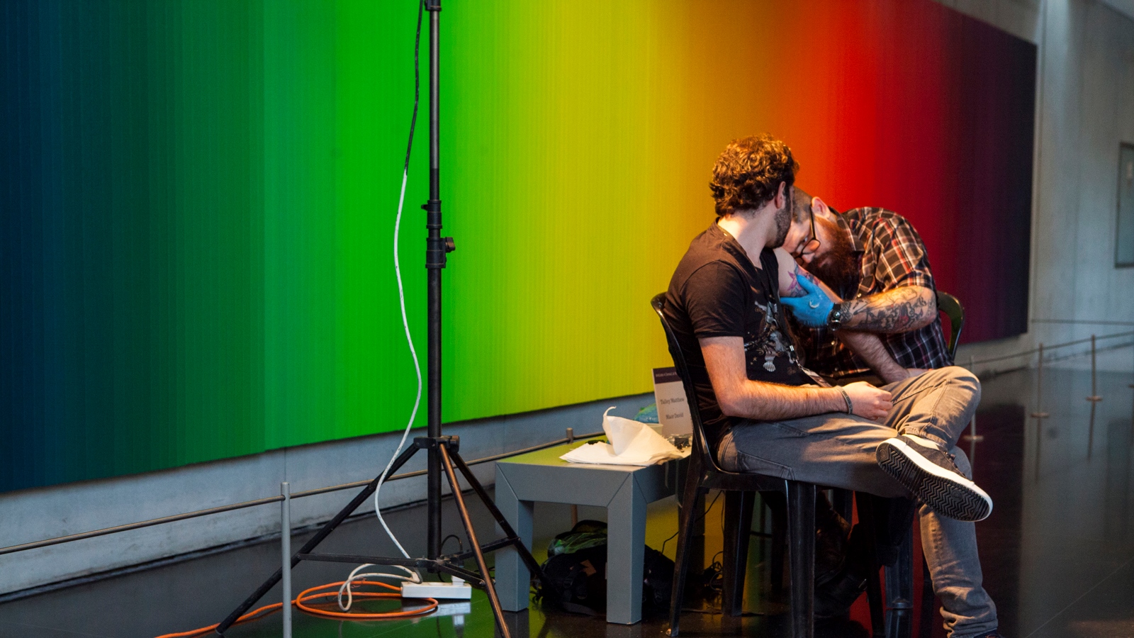 Talley Matthew tattoos Maor David in front of Olafur Eliasson's “Whenever the Rainbow Appears” at the Israel Museum. Photo: courtesy