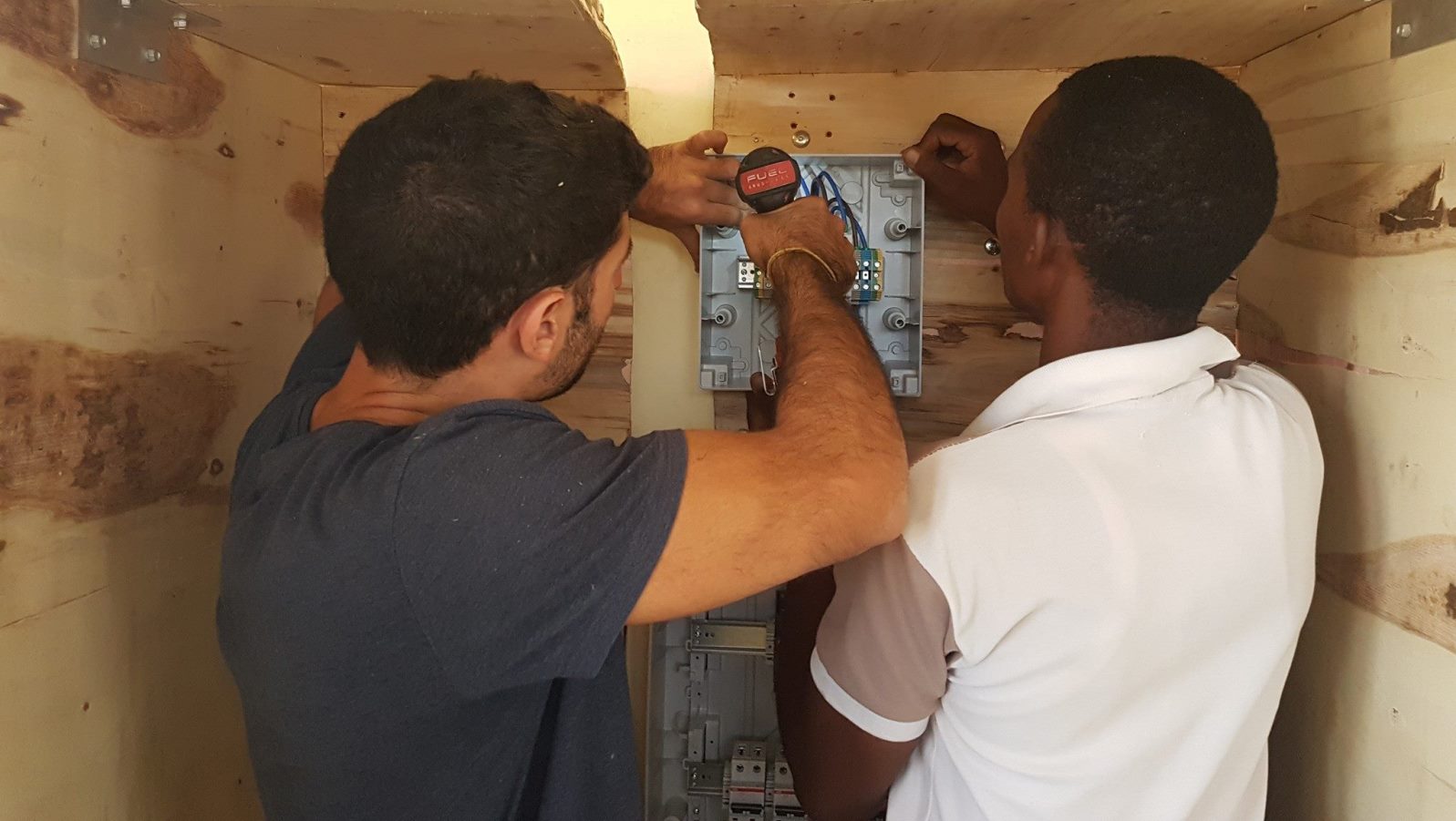 EwB TAU member Raz Cohen working with a Minjingu resident to install the solar generator. Photo via Facebook EwB TAU member Raz Cohen working with a Minjingu resident to install the solar generator. Photo via Facebook