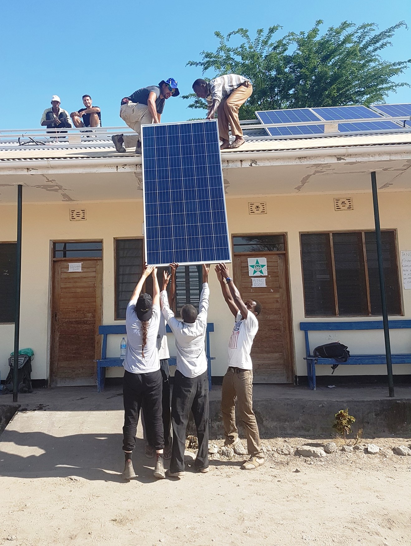 EwB TAU and local volunteers installing solar panels on the clinic’s roof. Photo via Facebook EwB TAU and local volunteers installing solar panels on the clinic’s roof. Photo via Facebook