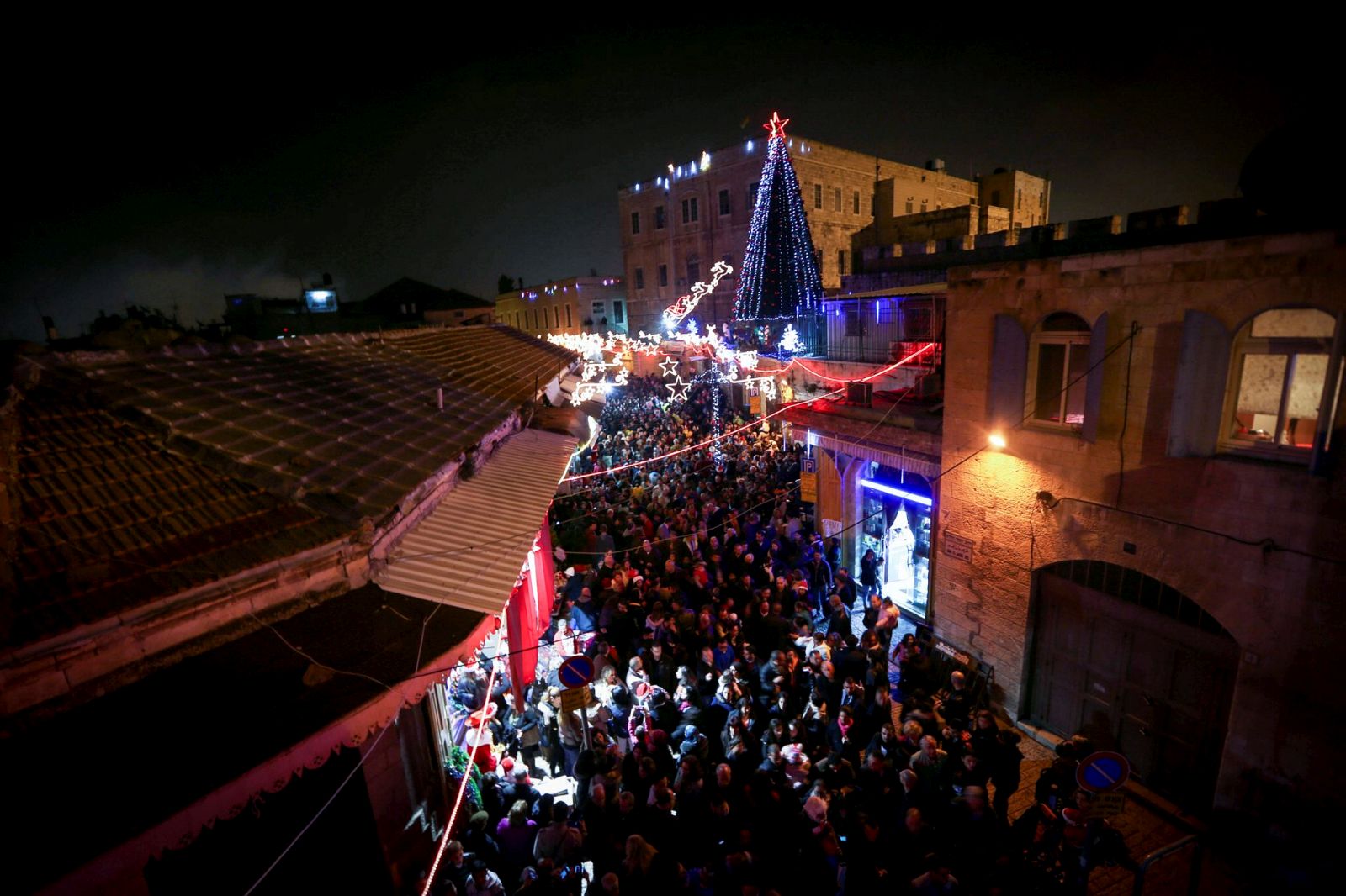 Hundreds of Christians celebrate the lighting of the Christmas tree in the Christian quarter of the Old City Of Jerusalem. Photo by Muath Al Khatib/Flash90.