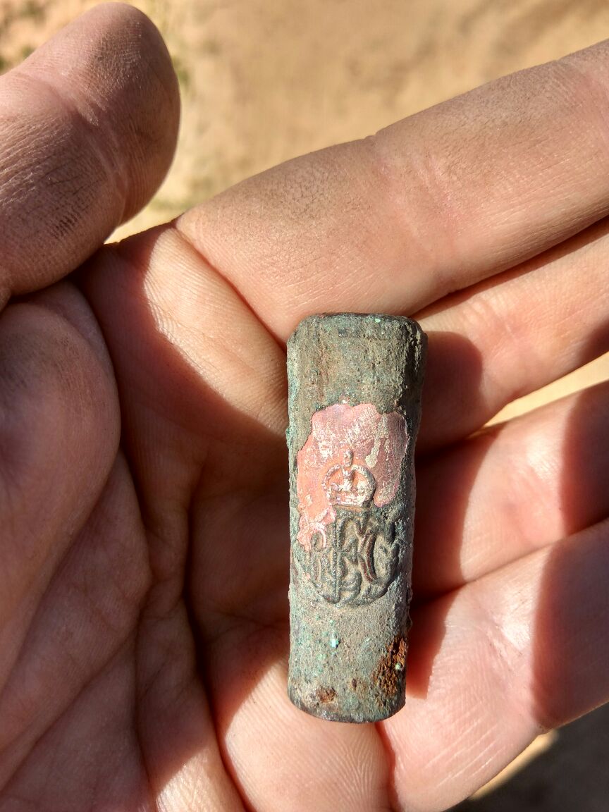 The silver tip of the swagger stick that is stamped with the symbol of the corps and the initials RFC. Photo by Ron Toueg, courtesy of Israel Antiquities Authority.