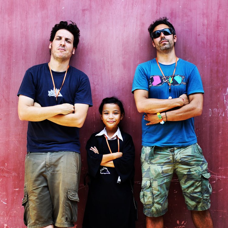 Keepod founders Nissan Bahar, left, and Franky Imbesi with a child wearing a Keepod for personal computing portability. Photo: courtesy