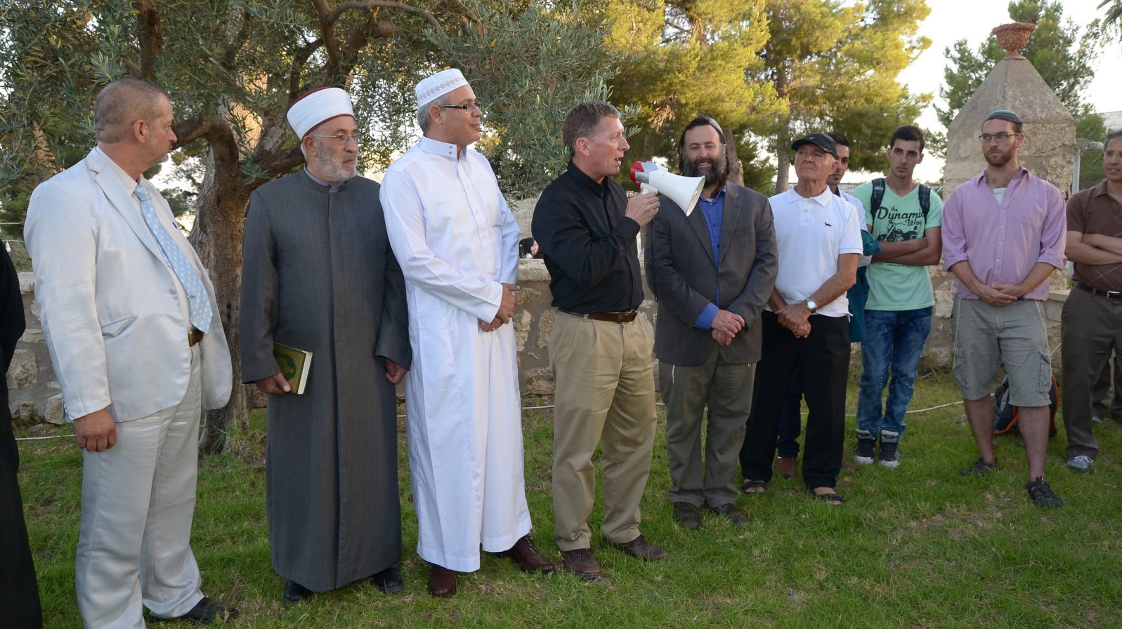 Father Russ McDougall of the Tantur Ecumenical Institute greets participants at the Iftar Dinner for Peace in 2015. Eliyahu McLean is to his left. Photo courtesy of Abrahamic Reunion