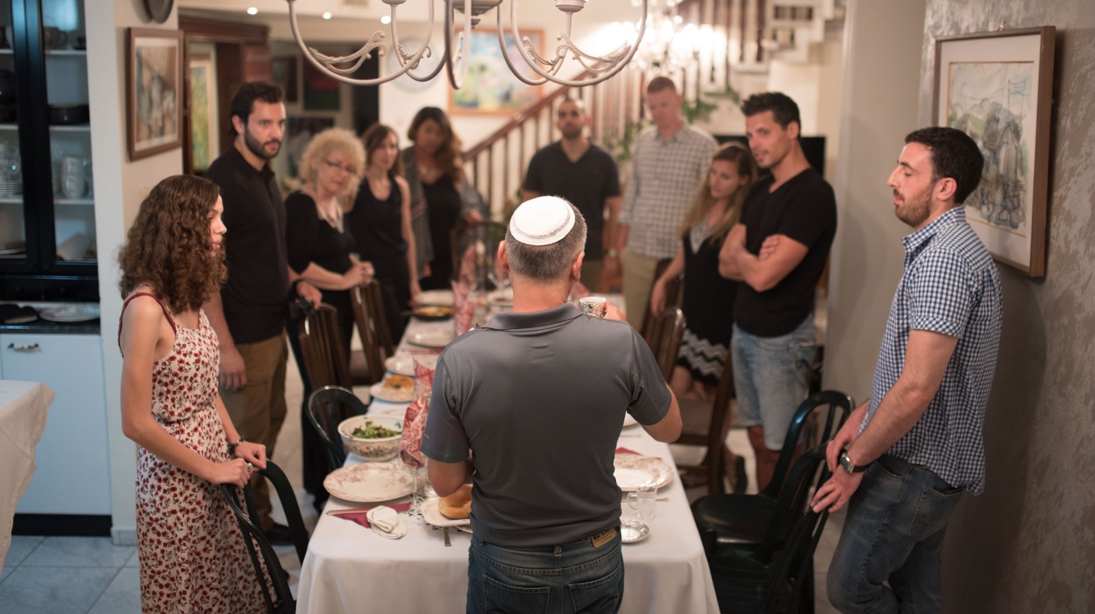 Travel bloggers from three countries share a Shabbat dinner with a Betzavata host in Israel. Photo by Or Kaplan