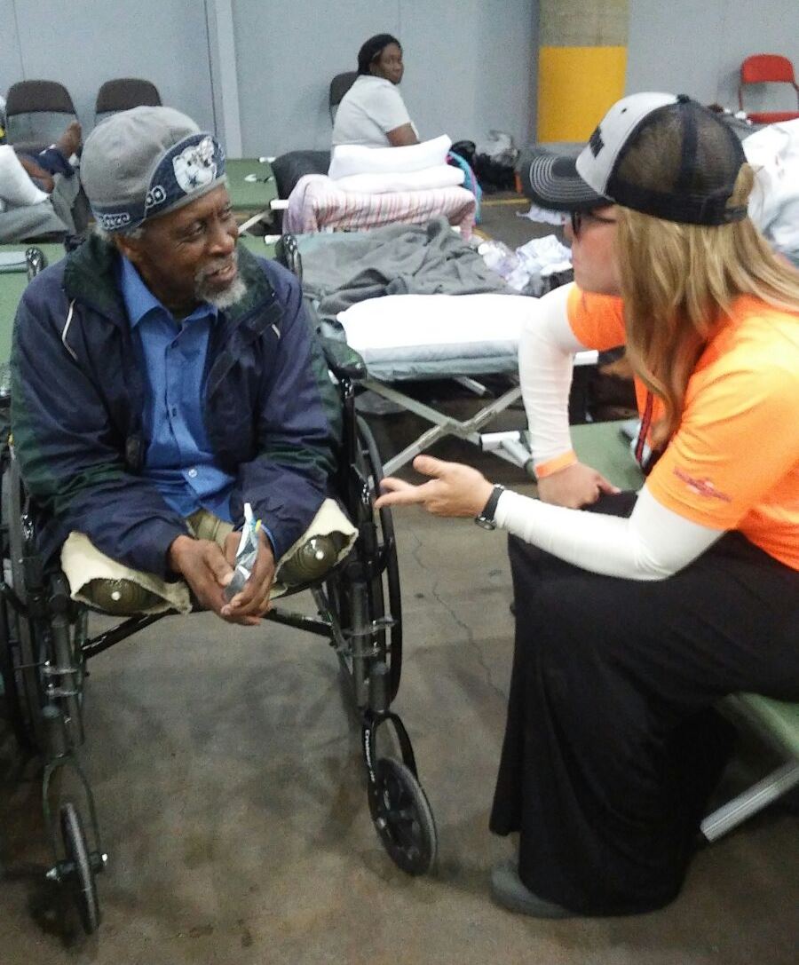 IRC team leader Miriam Ballin counseling a disabled Houston evacuee. Photo: courtesy