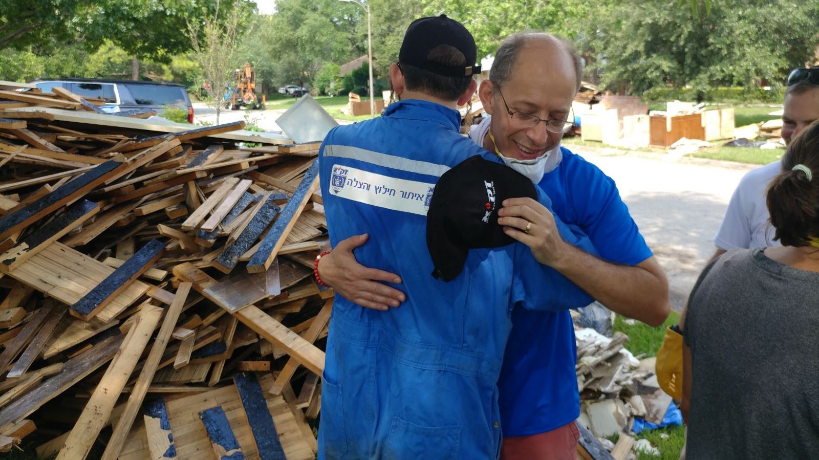 A ZAKA volunteer embracing another aid worker in Houston. Photo: courtesy