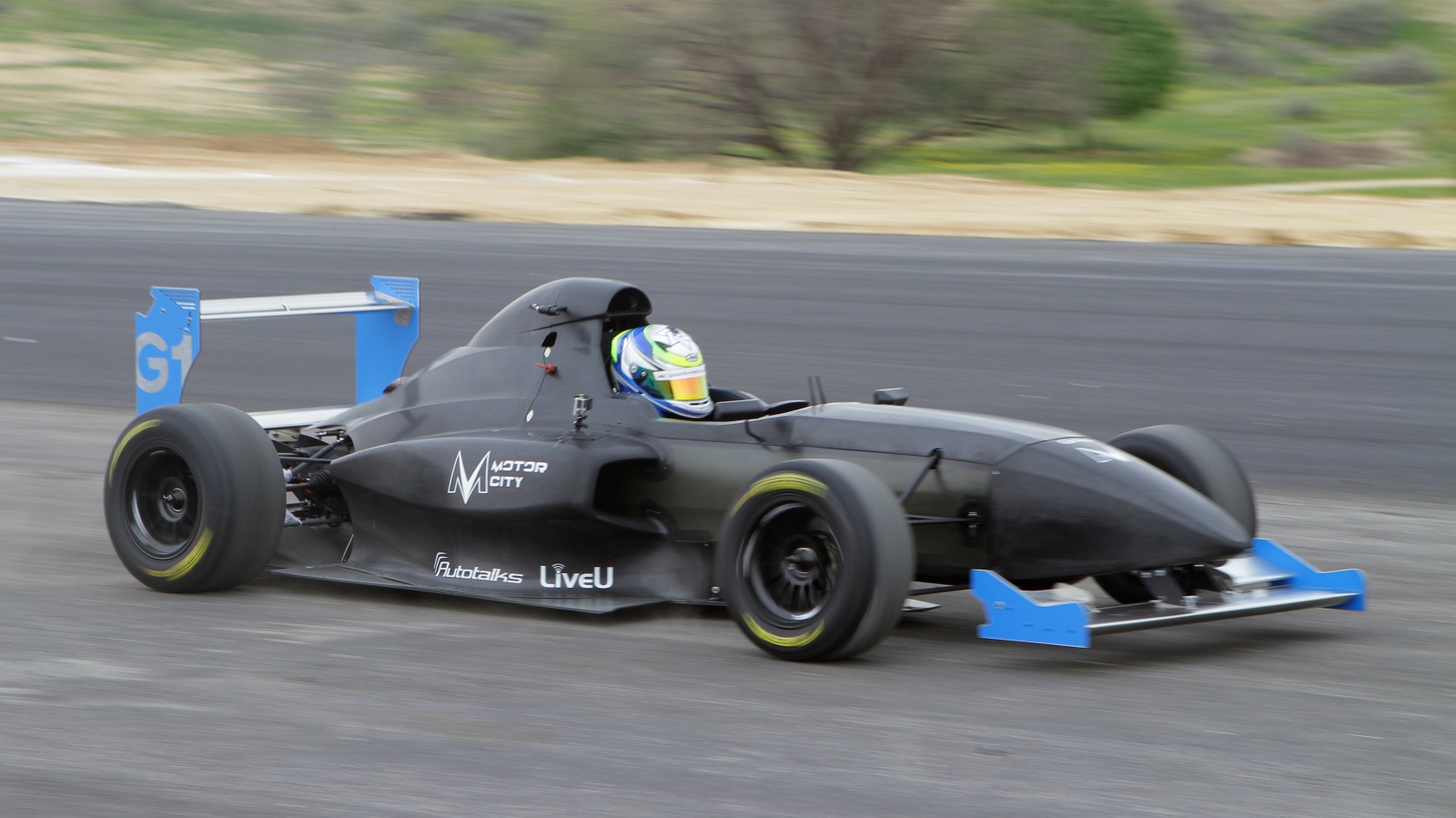 A Griiip G1 car racing down the Motor City track. Photo by Shahar Algazi