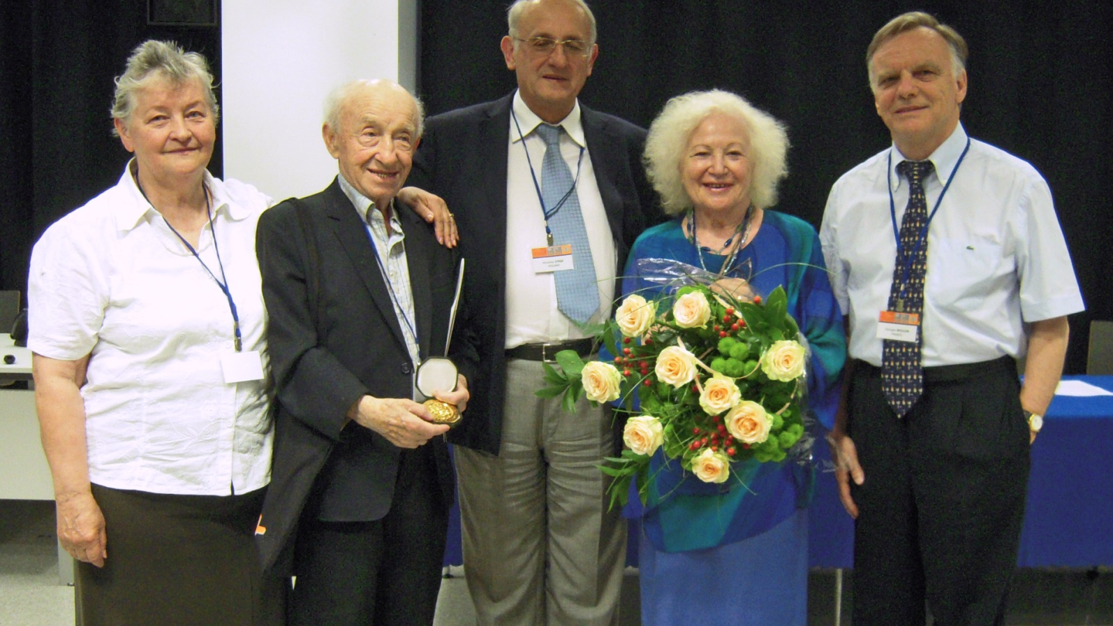 Prof. Renata Reisfeld (in blue) receiving the Gold Medal of the University of Wrocław, Poland, June 2011, surrounded by colleagues and her husband, Eliezer, second from left. Photo by Viktoria Levchenko via Wikimedia Commons