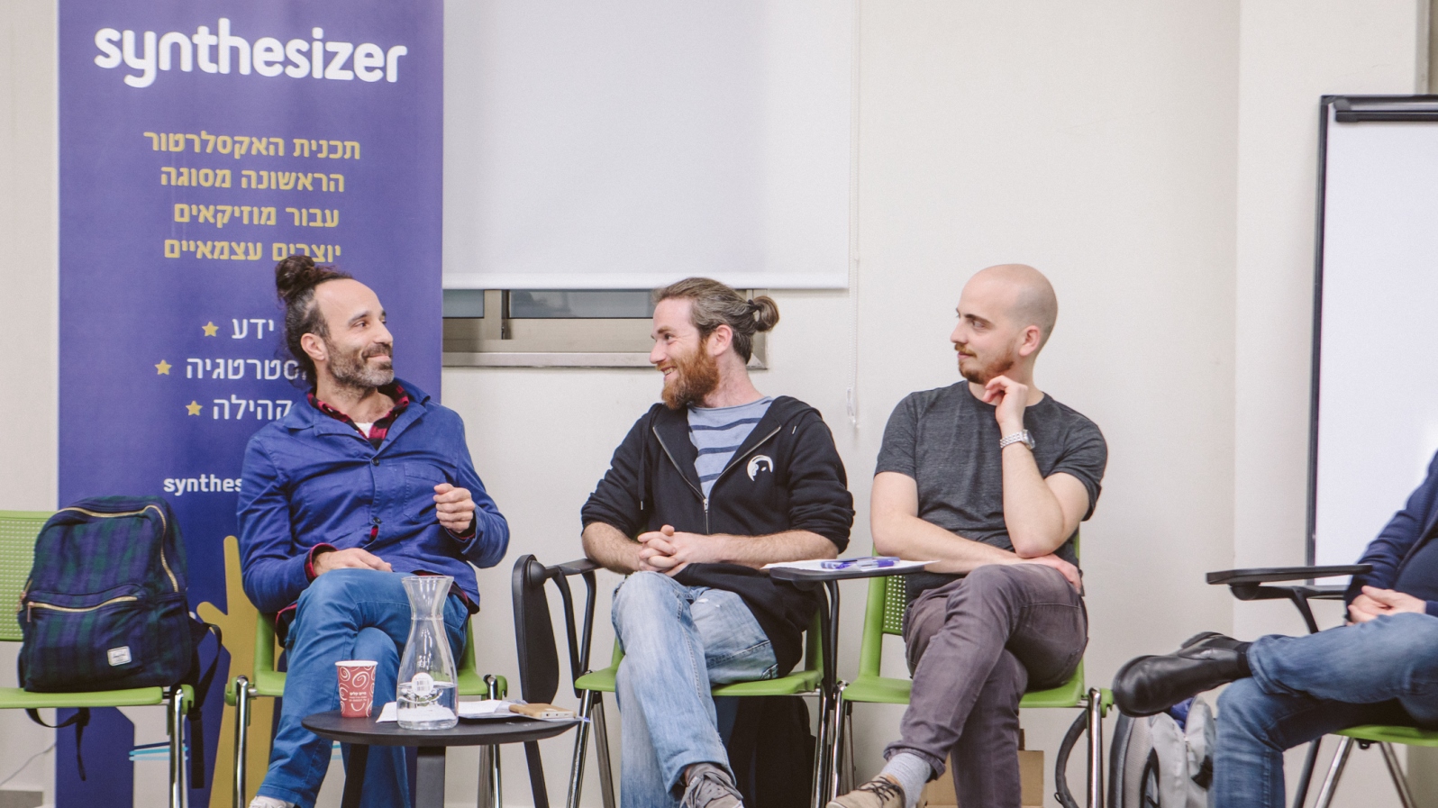 Balkan Beat Box founder Tamir Muskat, in blue, speaking to Synthesizer accelerator participants and mentors on opening day, Feb. 25, 2018. Photo by Tsofit Barabi
