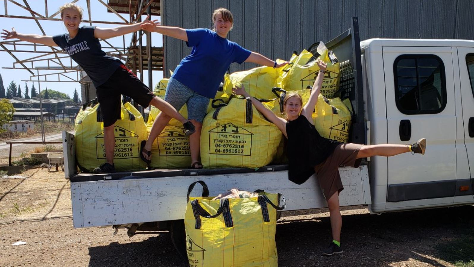 Young residents of Israel’s Golan Heights with building supplies collected for their Syrian neighbors. Photo courtesy of Golan Regional Council