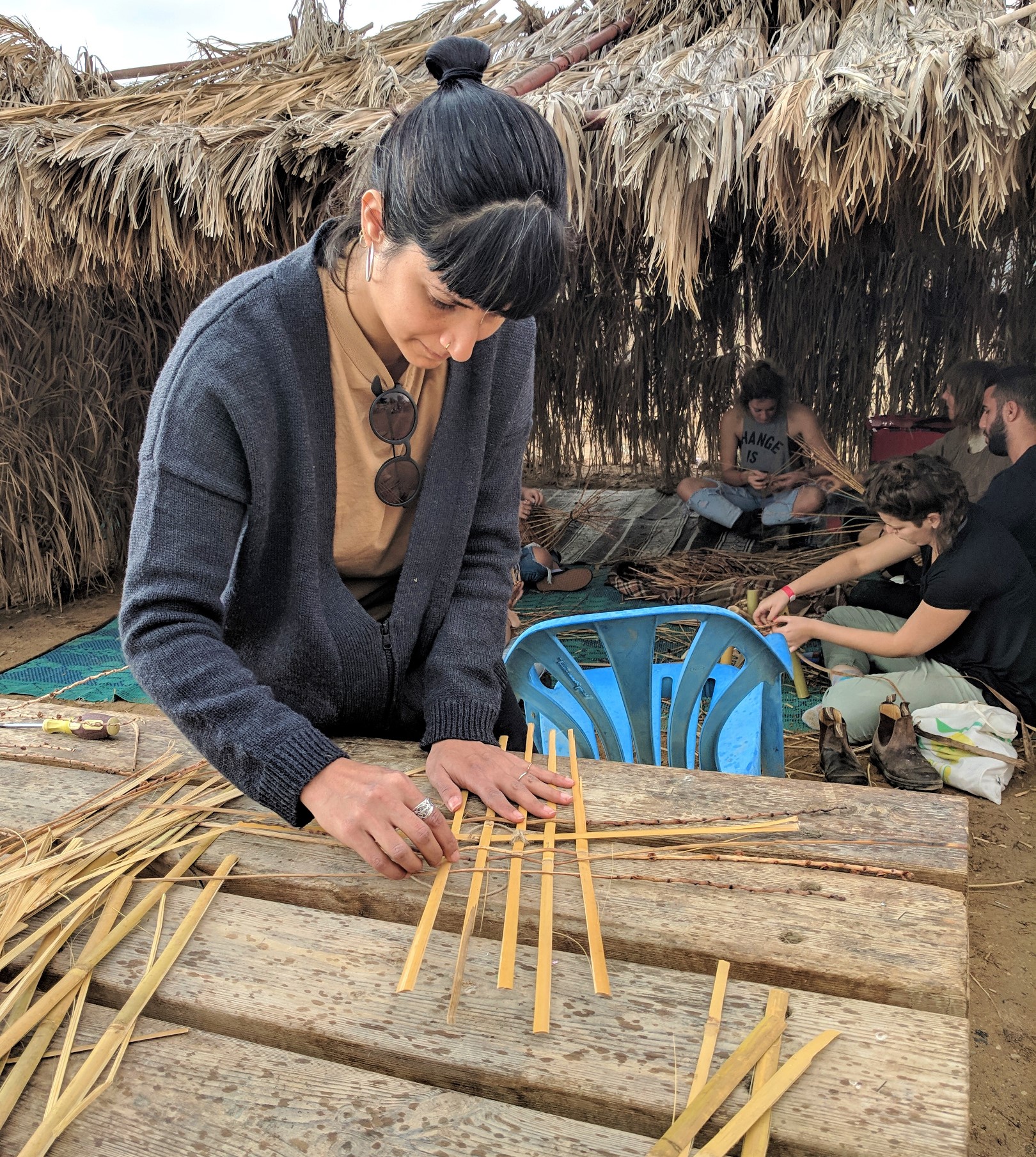 A student interlacing strips of bamboo to create the seat for a stool at Bezalel Academy’s annual Dead Sea Seminar. Photo: courtesy