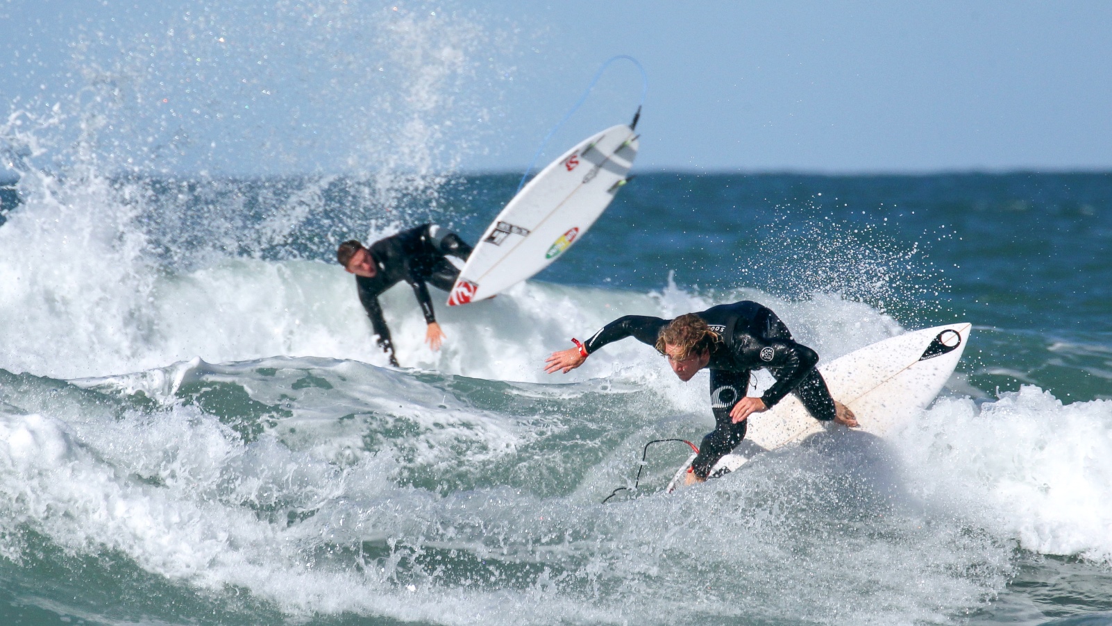 Two surfers struggling to stay on their boards in the 2019 SEAT Pro Netanya surfing competition, January 18, 2019. Photo by Flash90