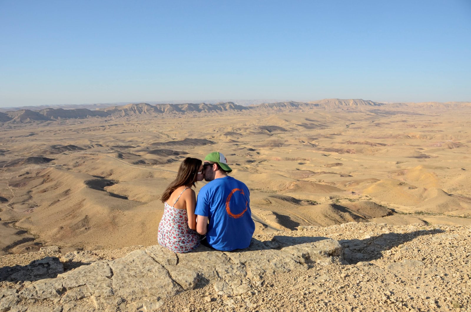 A couple sits by a lookout point of the Ramon Crater. Photo by Zoe Vayer/Flash90