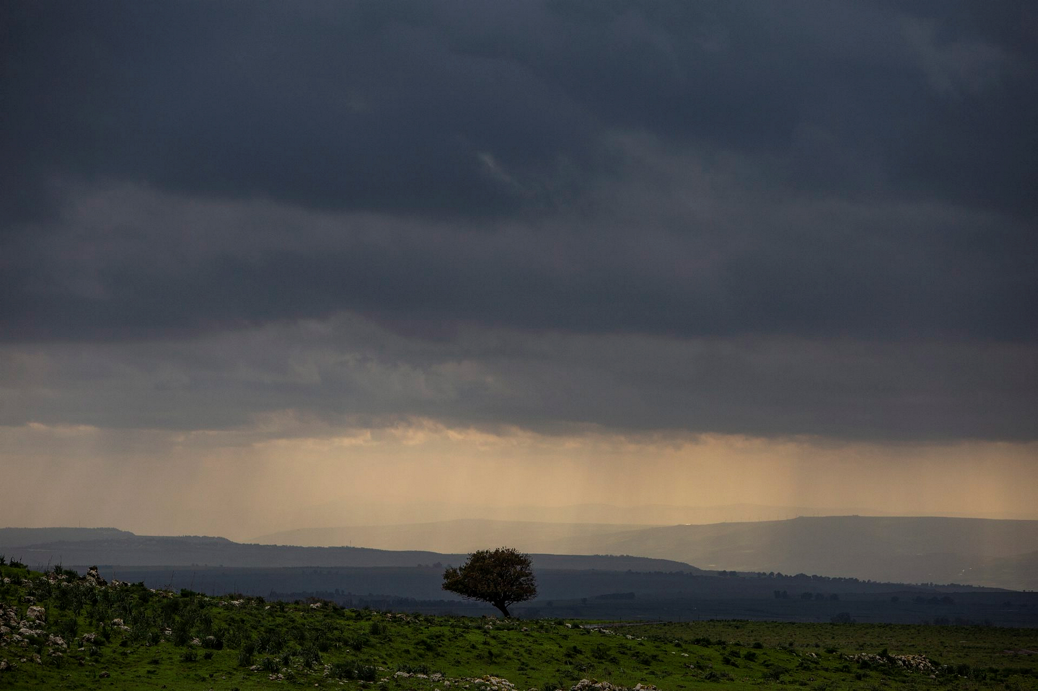 The sun breaks through clouds on a winter day in the Golan Heights, January 2019. Photo by Maor Kinsbursky/Flash90
