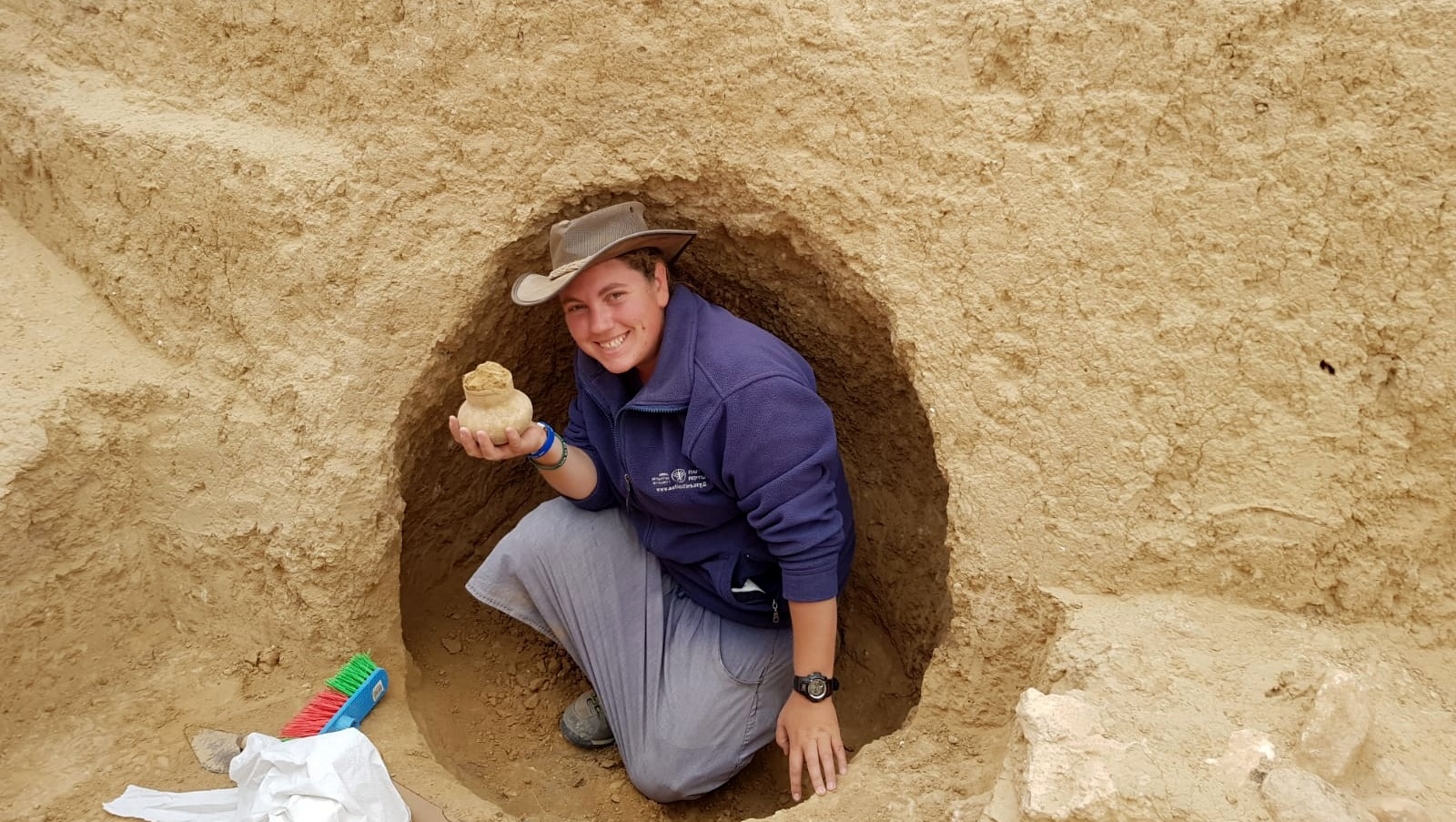 Archaeologist Shira Bloch holding a 2000-year-old vessel discovered in the excavation. Photo courtesy of Israel Antiquities Authority