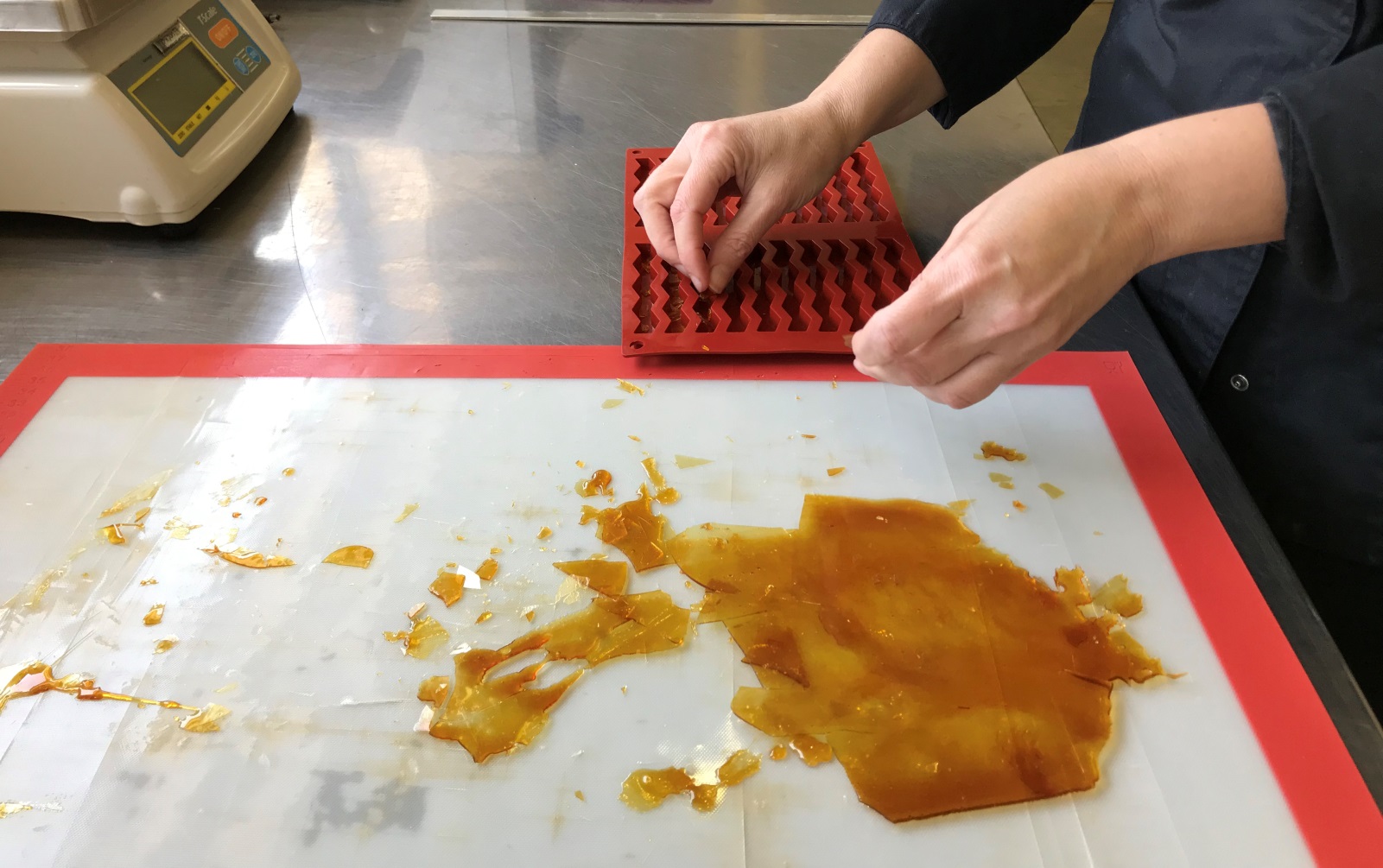 Chopping up caramel for chocolate finger decorations at IKA Chocolate. Photo by Naama Barak
