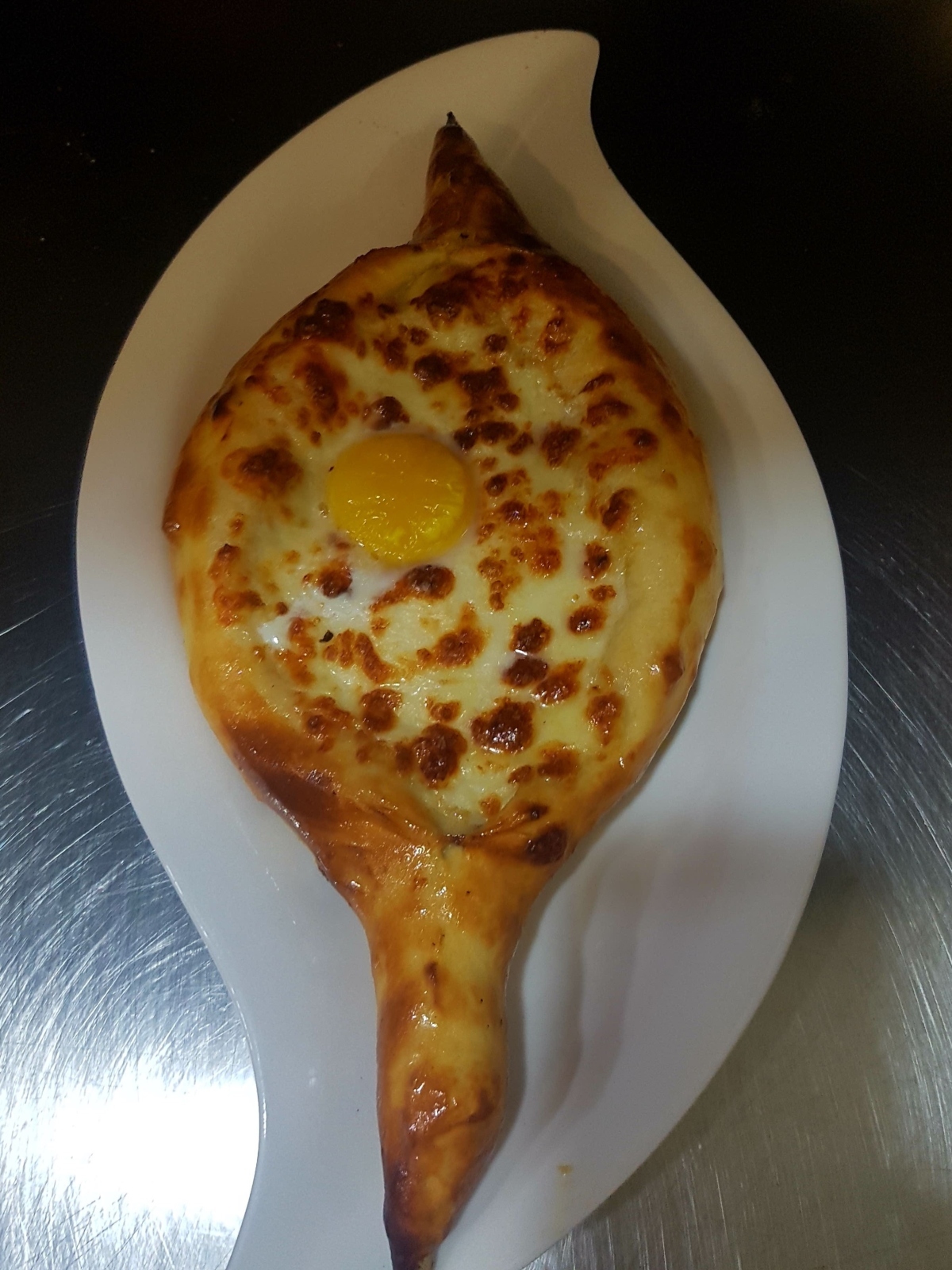 Khachapuri is a traditional Georgian bread boat containing cheese and a fried egg. Photo courtesy of Georgia restaurant