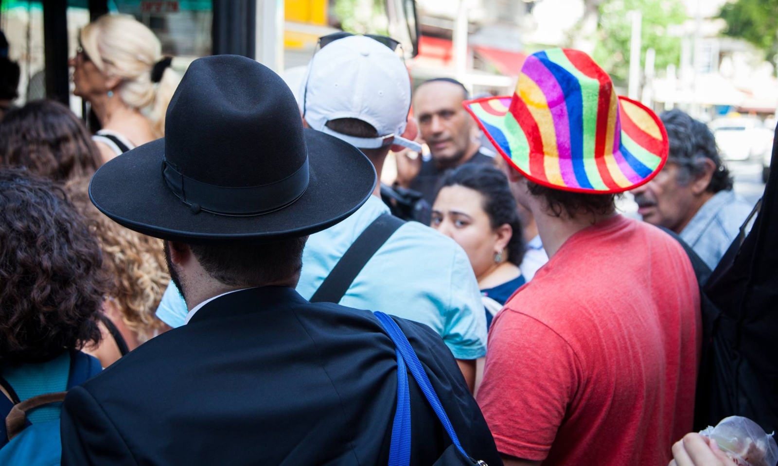 Similar hats, worlds apart. Photo by Evyatar Dayan/ThisIsTelAviv