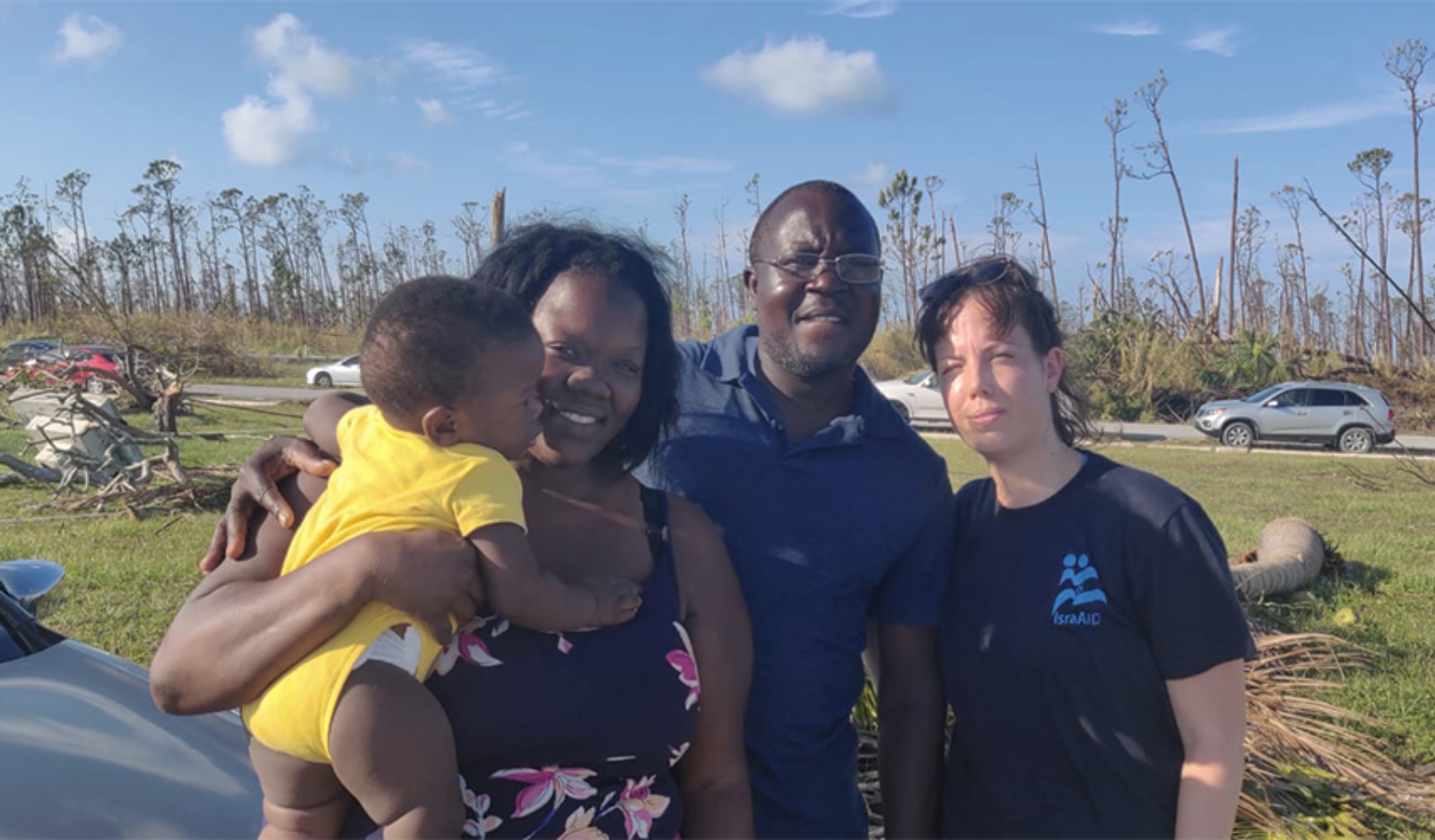 Sheerin and Batisse from Abaco, shown here with IsraAID’s Michal Bar, have been living in their car with their children after Hurricane Dorian destroyed their community. Photo courtesy of IsraAID