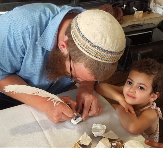 Each attendee of Kalman Gavriel’s scribal arts workshops takes home a Jerusalem stone on which he has inscribed their name in Hebrew letters. Photo: courtesy